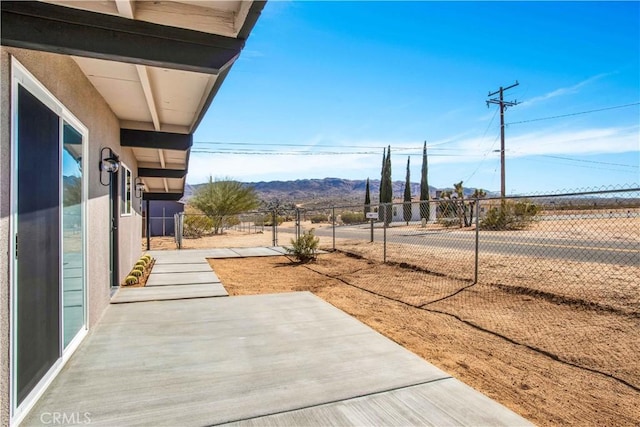 exterior space with a patio and a mountain view