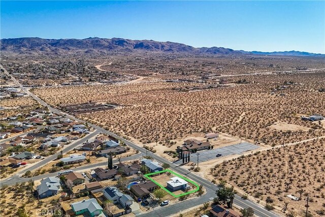 birds eye view of property featuring a mountain view