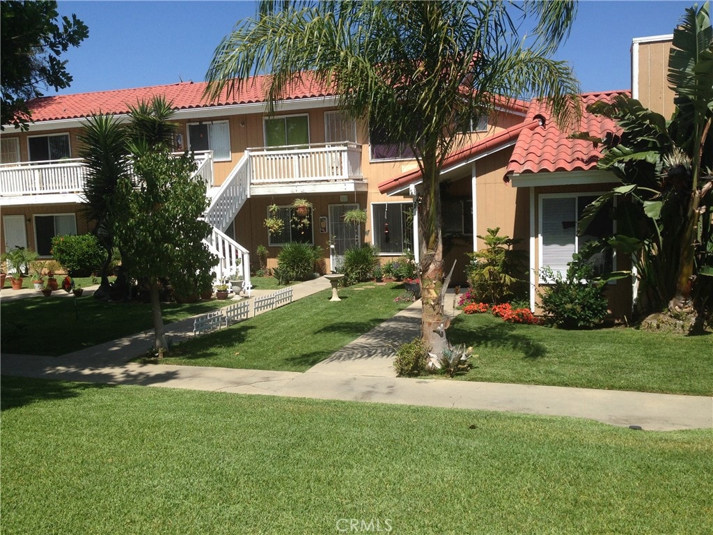 view of front of property with a front lawn and a balcony