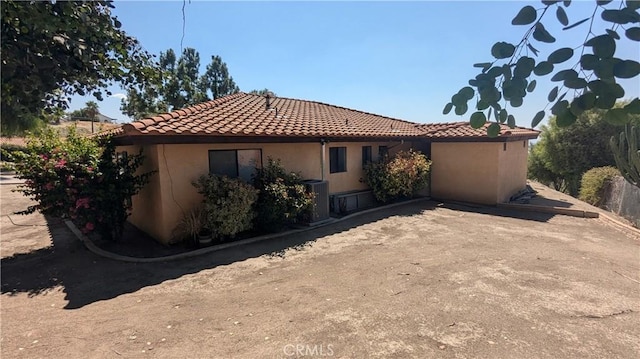 rear view of property featuring central AC