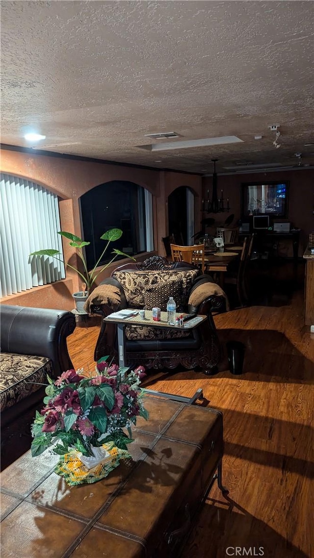 living room with hardwood / wood-style floors and a textured ceiling