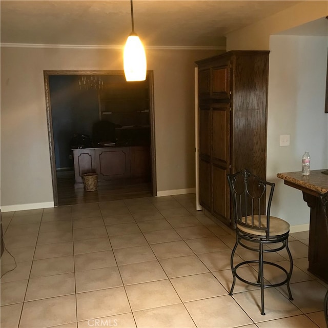 dining space featuring light tile patterned floors and ornamental molding