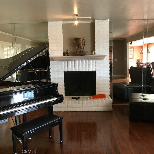 miscellaneous room with a fireplace, hardwood / wood-style floors, and ornamental molding