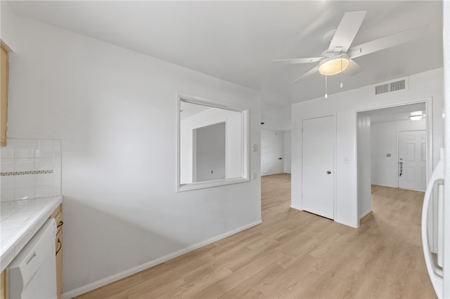 interior space with ceiling fan and light wood-type flooring