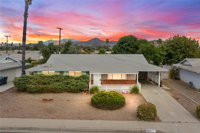 view of front facade featuring a carport and a mountain view