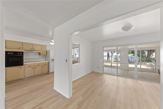 unfurnished living room with ceiling fan and light hardwood / wood-style flooring