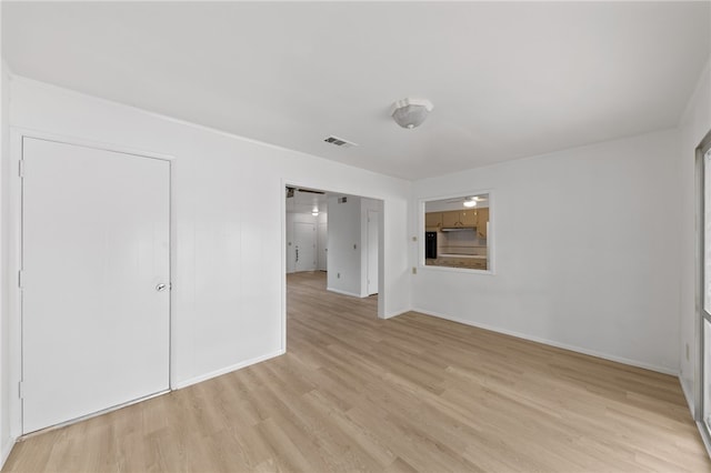 spare room featuring light hardwood / wood-style floors