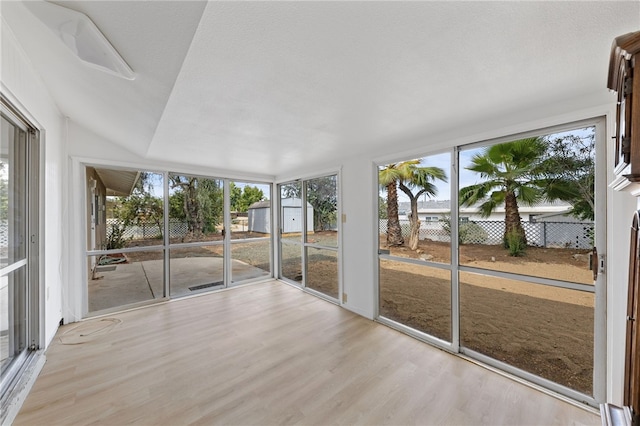 unfurnished sunroom with vaulted ceiling