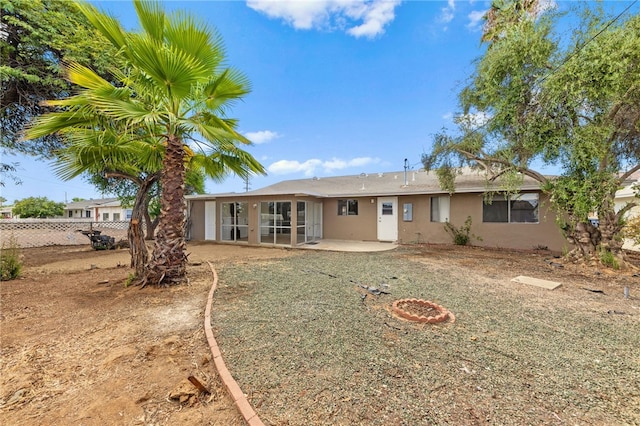 rear view of property featuring a patio area