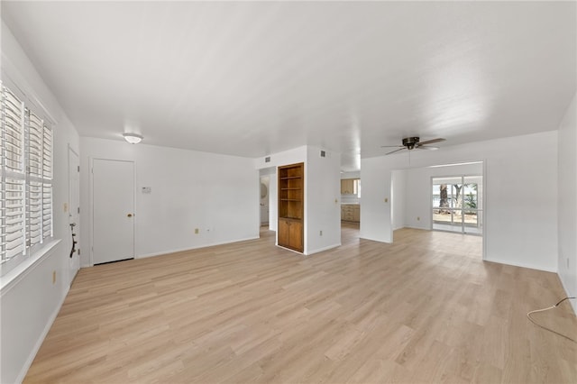 unfurnished living room featuring ceiling fan and light hardwood / wood-style floors