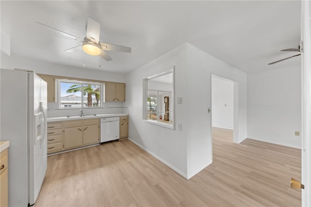 kitchen with white appliances, sink, ceiling fan, tasteful backsplash, and light hardwood / wood-style floors