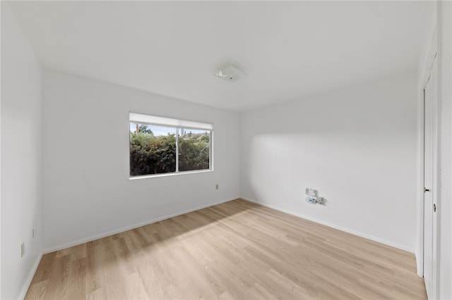 unfurnished room with light wood-type flooring