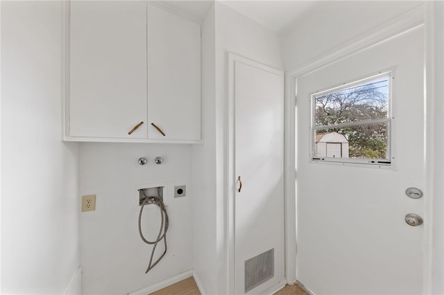 laundry area featuring cabinets, hookup for a washing machine, and electric dryer hookup