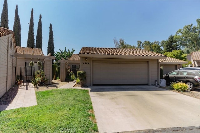 view of front of home featuring a garage and a front lawn