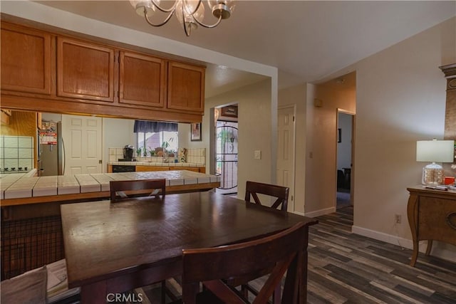 dining area featuring dark hardwood / wood-style flooring and a chandelier