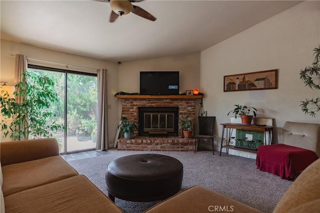 carpeted living room with ceiling fan, lofted ceiling, and a fireplace