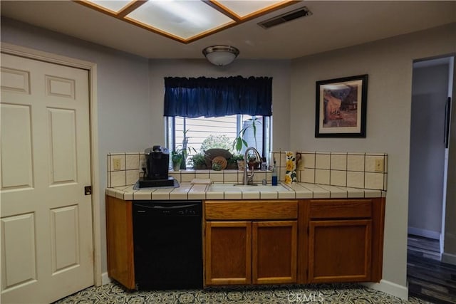 kitchen featuring tile countertops, dishwasher, light hardwood / wood-style floors, and sink