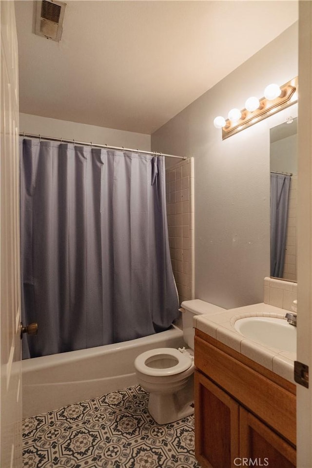 full bathroom with tile patterned floors, vanity, toilet, and shower / bath combo with shower curtain