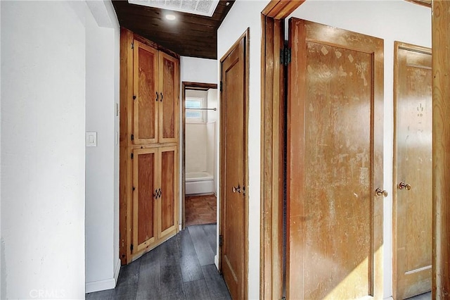 hallway with dark hardwood / wood-style flooring