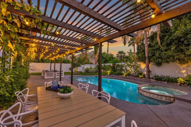 pool at dusk with a pergola and an in ground hot tub