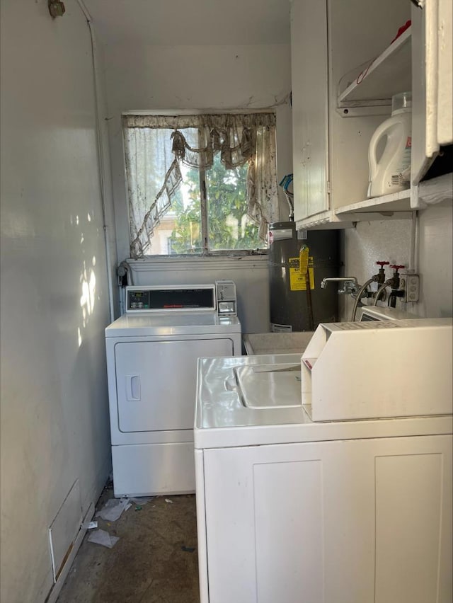 clothes washing area with water heater and washing machine and clothes dryer