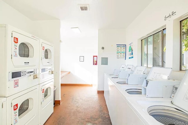 laundry room with washing machine and dryer and stacked washer and dryer