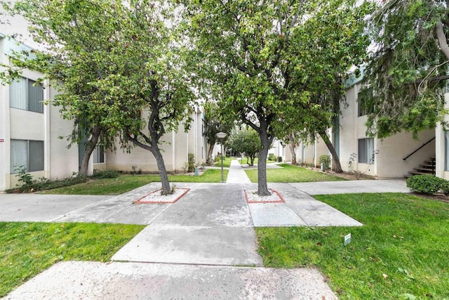 view of home's community featuring a lawn