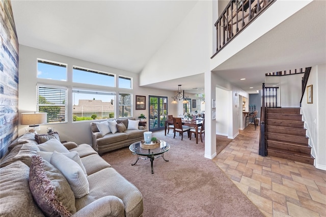 living room featuring a chandelier and a high ceiling