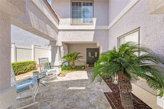 property entrance featuring a patio area