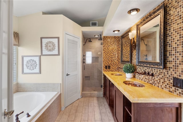 bathroom featuring hardwood / wood-style floors, vanity, and independent shower and bath