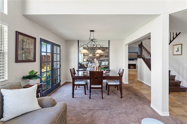 dining space featuring carpet floors and french doors