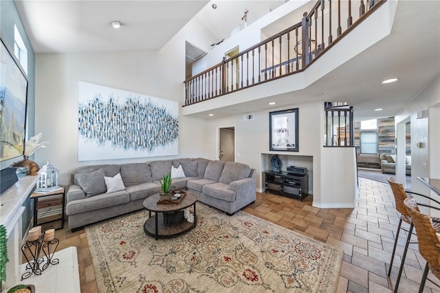 living room featuring plenty of natural light and a high ceiling