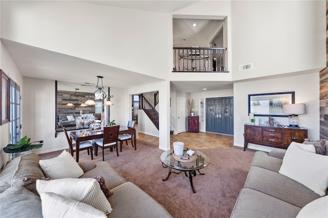 living room featuring a notable chandelier and a high ceiling