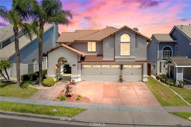 view of front of home featuring a yard and a garage