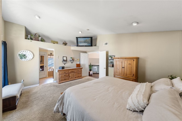 carpeted bedroom with vaulted ceiling