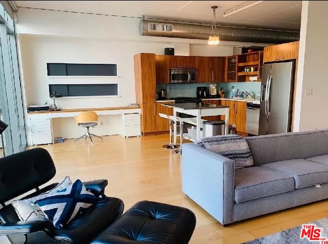 living room with light wood-type flooring and built in desk