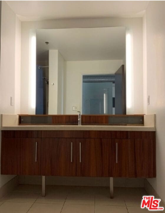 bathroom with tile patterned flooring and sink