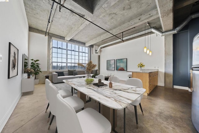 dining space featuring concrete floors