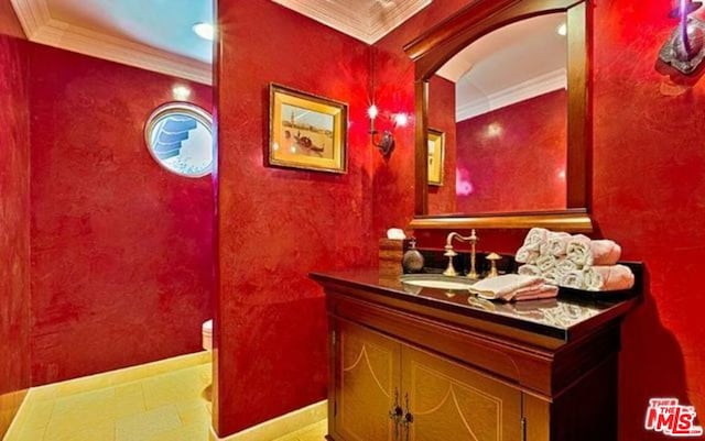 bathroom with crown molding, vanity, and toilet