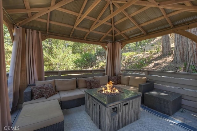 view of patio featuring an outdoor living space with a fire pit and a gazebo