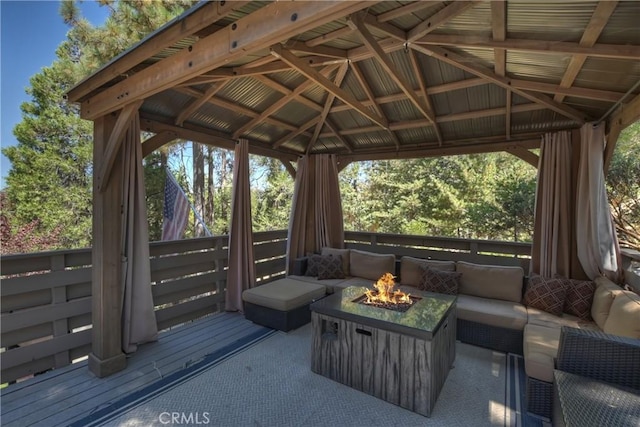 deck with a gazebo and an outdoor living space with a fire pit