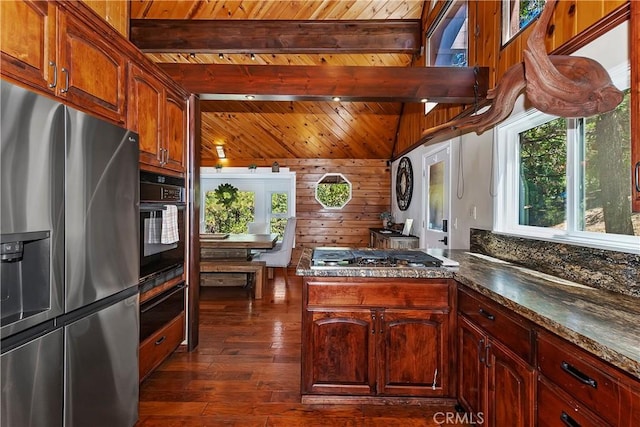 kitchen featuring wood ceiling, dark wood-type flooring, stainless steel appliances, beamed ceiling, and wood walls