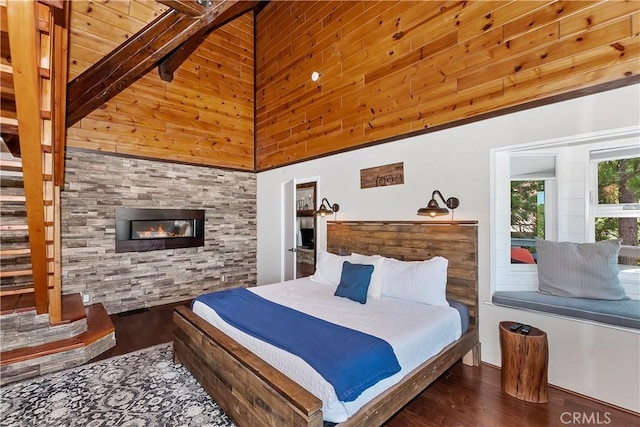 bedroom with high vaulted ceiling, beam ceiling, and dark hardwood / wood-style floors