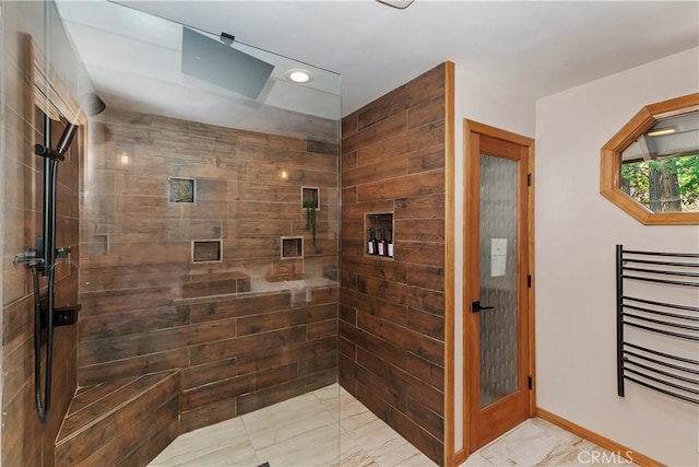 bathroom with radiator and a tile shower