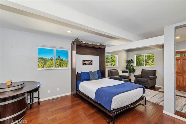 bedroom with dark wood-type flooring