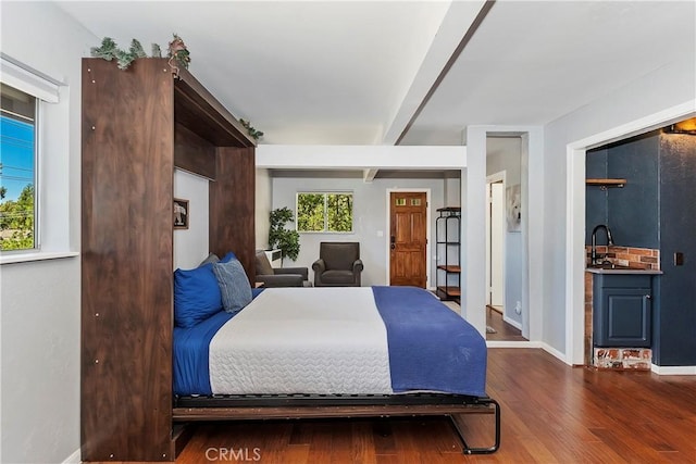 bedroom featuring dark hardwood / wood-style flooring and beamed ceiling