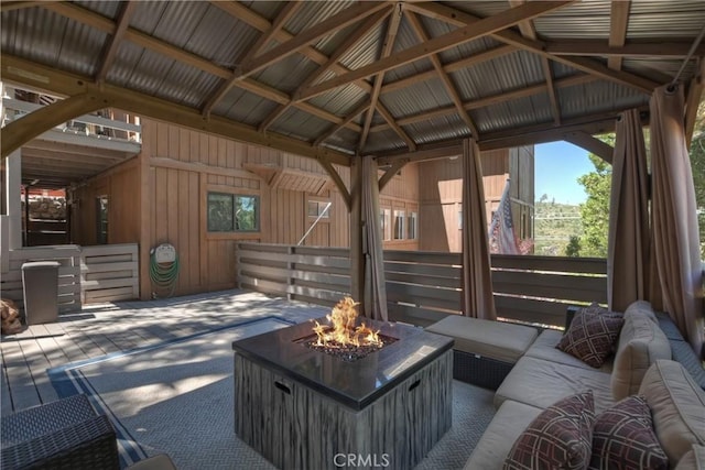 view of patio with an outdoor living space with a fire pit and a gazebo