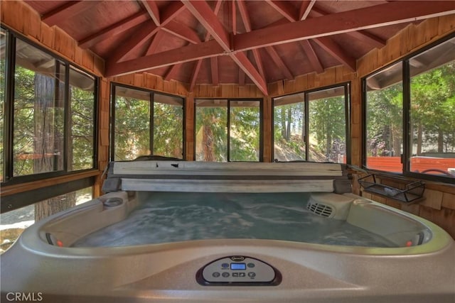 unfurnished sunroom with wooden ceiling, a hot tub, and vaulted ceiling with beams