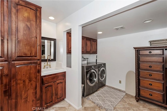 clothes washing area featuring cabinets, separate washer and dryer, and sink