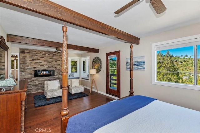 bedroom featuring ceiling fan, dark hardwood / wood-style flooring, beamed ceiling, and multiple windows